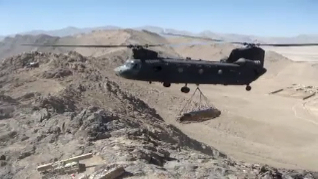 View the Video: An unknown CH-47D Chinook helicopter resupplies a mountain top Observation Post somewhere in eastern Afghanistan.
