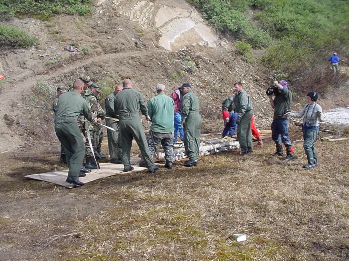 Icky is carefully pulled down a plywood road and towards the helicopter.