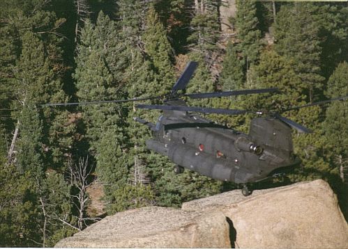 An MH-47E Chinook makes a one gear landing. Tail number, location, and place unknown.