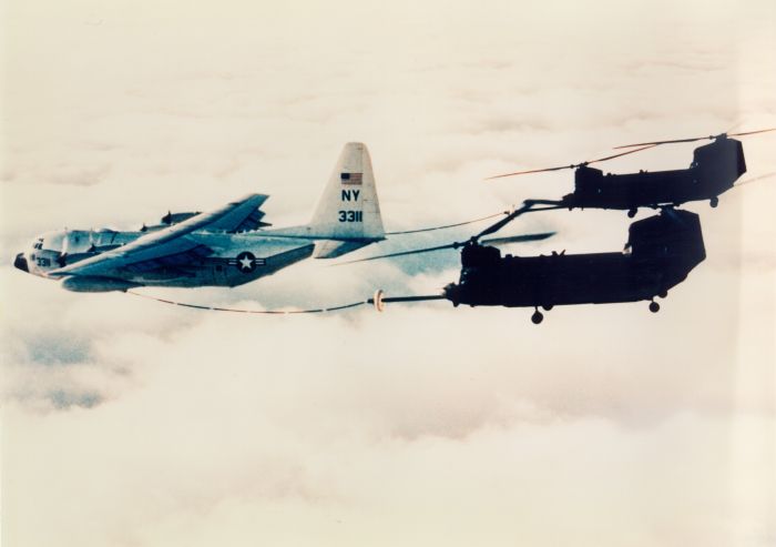 A pair of MH-47E models conducting in-flight refueling.