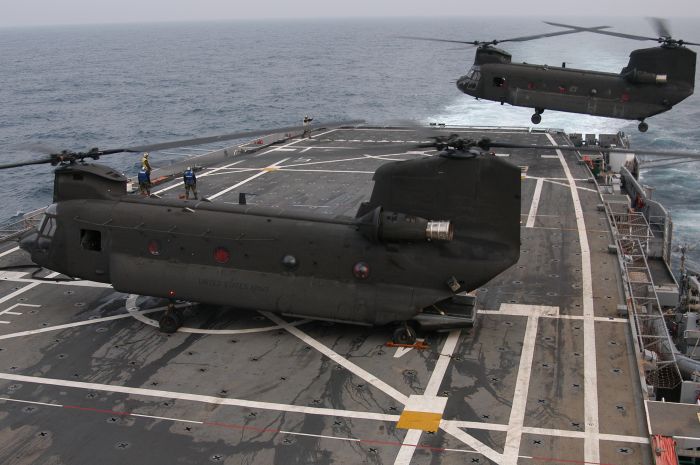 A pair of Boeing CH-47D Chinooks, tail numbers unknown, conduct shipboard operations off the southeast coast of South Korea.