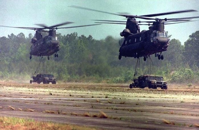 Boeing CH-47D slings a truck or two.