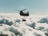 CH-47 transporting external cargo high above the clouds.