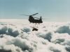 CH-47 transporting external cargo high above the clouds.