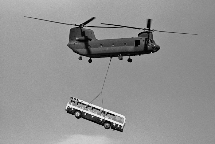 August 1980: CH-47A Chinook helicopter 65-08009 is seen transporting a bus via sling load at an unknown location. At the time, 65-08009 was property of the 92nd Aviation Company - "Hook-ers", United States Army Reserve (USAR), located at Paine Field (KPAE), Everett, Washington.