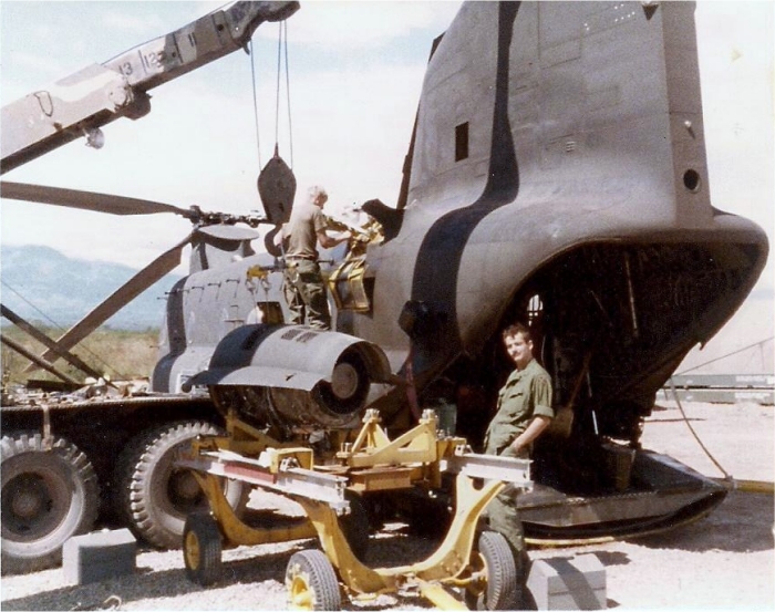 CH-47C Chinook helicopter 69-17111 equipped with T-55-L11D engines receives a powerplant change at Camp Black Jack, Soto Cano Air Base, circa 1984. The aircraft's Flight Engineer, SGT John Evans, stands in the foreground.