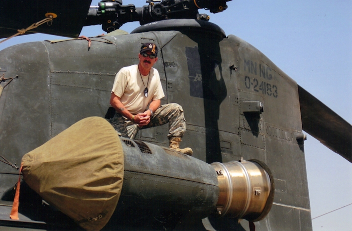 July 2011: SSG Jeffrey L. Stokes, Flight Engineer,  stands near the number one engine of Chinook helicopter 84-24183 at Taji Air Force Base, Iraq.