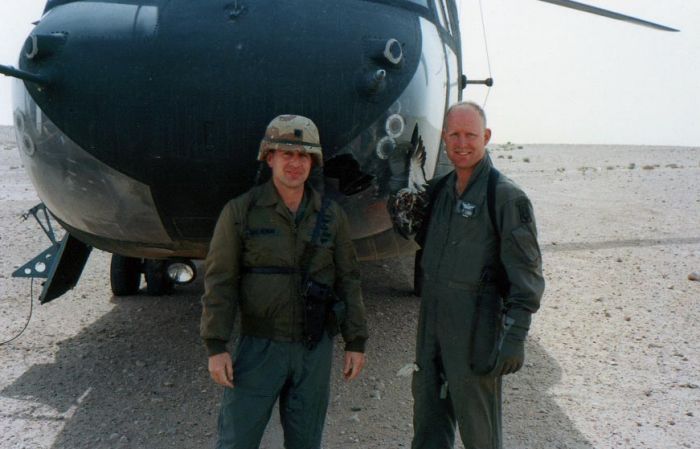 LTC Mulvenon (left) and SSG Shane Curtis standing in front of 85-24335 while deployed to the desert sand in Iraq, circa 1991.