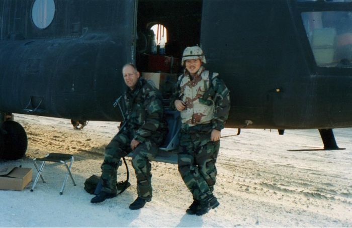 SSG Shane Curtis (left), Flight Engineer, and WO1 Jay Watson near the main cabin door of 85-24335.