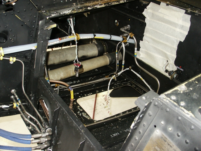 The left chin bubble area of CH-47D Chinook helicopter 85-24336 showing the compartment under the copilot's seat.