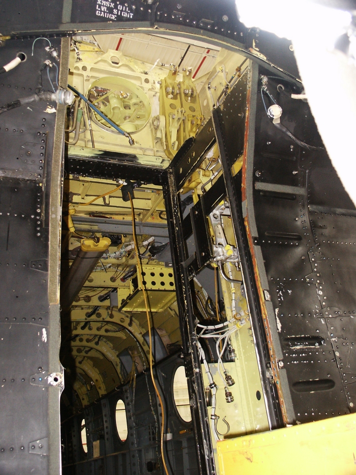 The companion way area of CH-47D Chinook helicopter 85-24336 showing the first stage mixing units of the primary flight controls.
