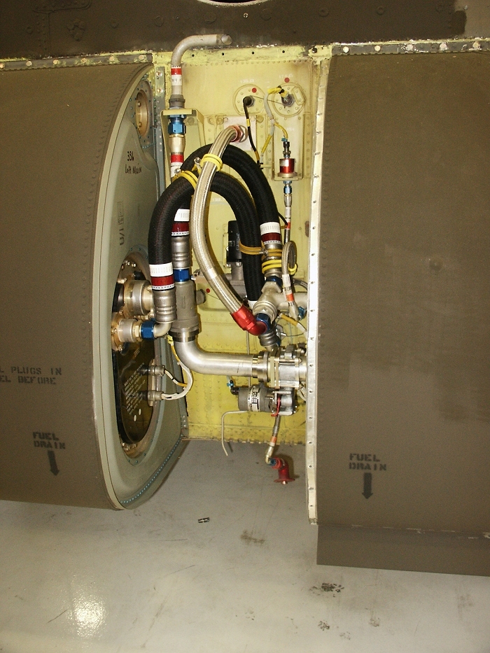 The left aft inter-tank area of CH-47D Chinook helicopter 85-24336 showing the APU fuel pump and left aft auxiliary fuel pump pressure switch.