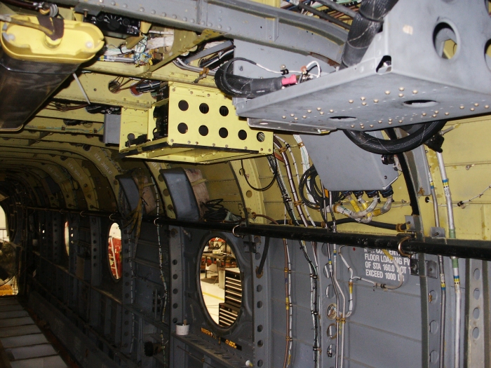 The left forward main cabin area of CH-47D Chinook helicopter 85-24336 showing a micro climate unit (MCU) mount and the intercom control system (ICS) control unit.