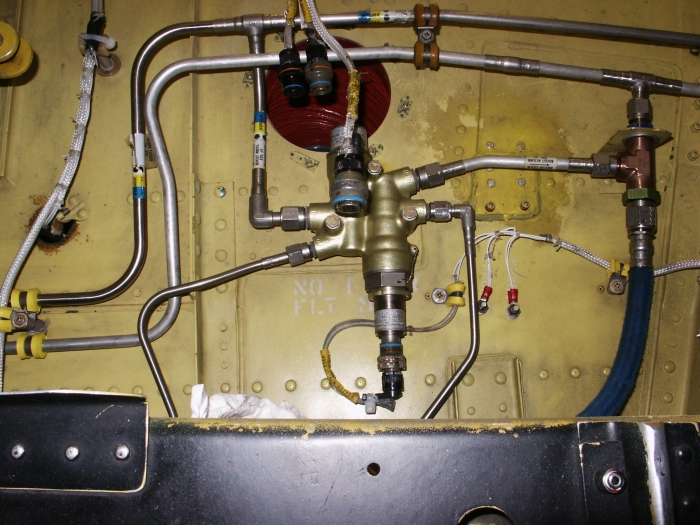 The number one flight hydraulic system lower controls pressure control module (LCPCM) of CH-47D Chinook helicopter 85-24336 located in the flight controls closet.
