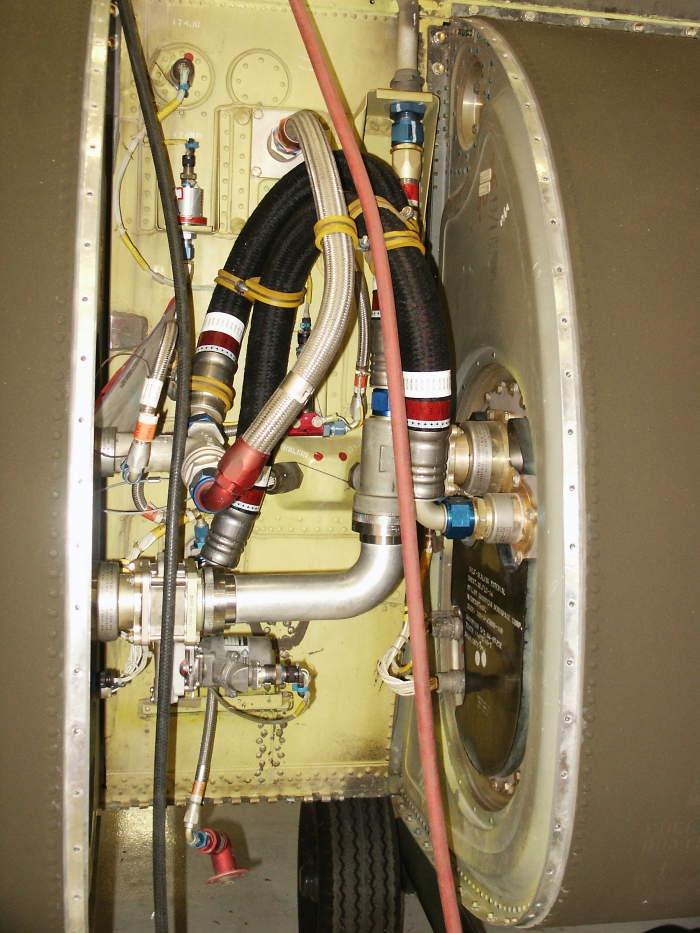 The right inter tank access area of CH-47D Chinook helicopter 85-24336 which is located just aft of the right main fuel tank. The right aft auxiliary fuel tank fuel pressure switch can be seen as well as the auxiliary fuel tank refueling gate valve, various fuel fittings and lines.