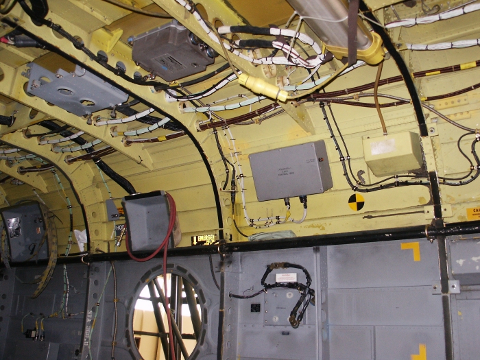The right inside cabin area of CH-47D Chinook helicopter 85-24336 showing the number two engine digital electronic control unit (DECU) and the number two engine air particle separator (EAPS) control box.
