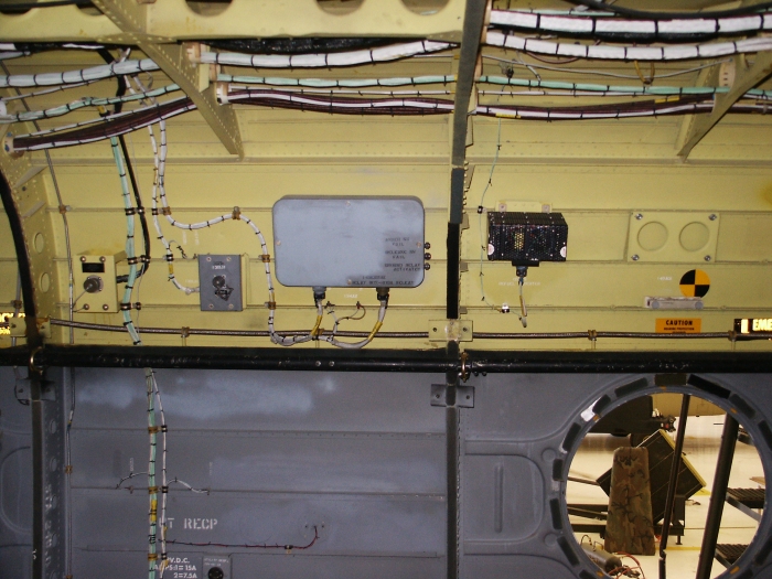 The right inside cabin area of CH-47D Chinook helicopter 85-24336 showing the cargo hook control unit (gray box) and the refueling station power supply (black box).