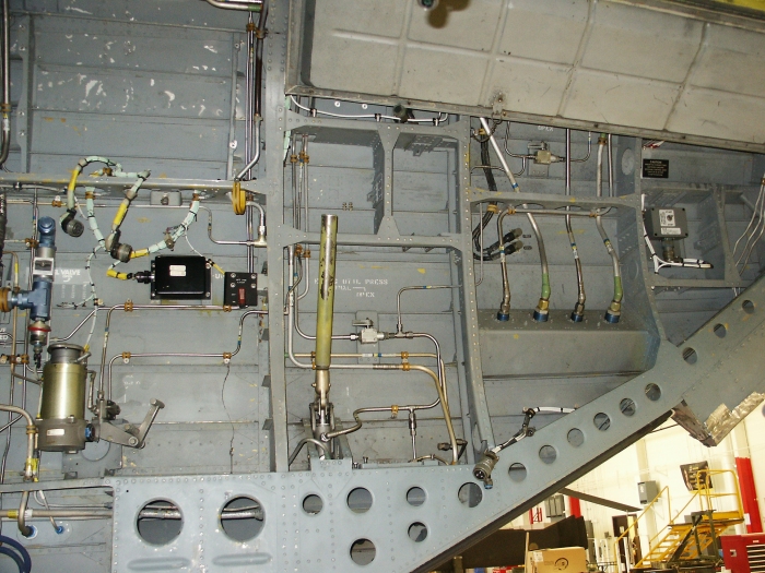 The right inside ramp area of CH-47D Chinook helicopter 85-24336 showing the number one and two flight boost hydraulic system and utility hydralic sytem fill module, the manual hand pump used to pressure the utility hydraulic system, the chip fuzz burn off module and the aft position light on/off switch.