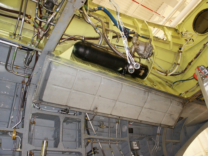 The right inside ramp area of CH-47D Chinook helicopter 85-24336 showing the 375 inch utility accumulator and the utility system hydraulic pump.