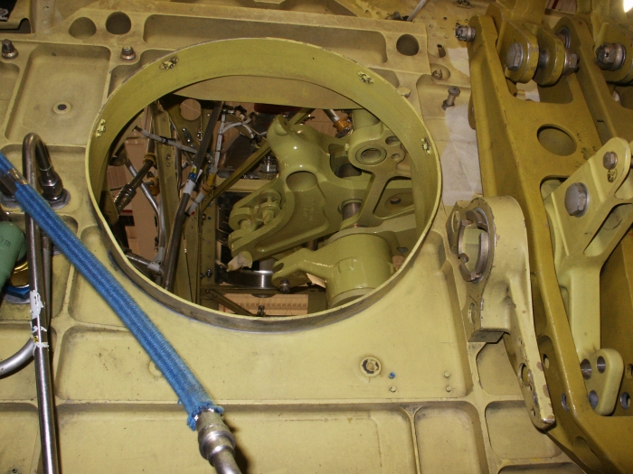 The bottom of the second stage mixing unit of CH-47D Chinook helicopter 85-24336 is visible through the large hole in the center of the photograph. A portion of the first stage mixing unit is visible on the extreme right of the image.