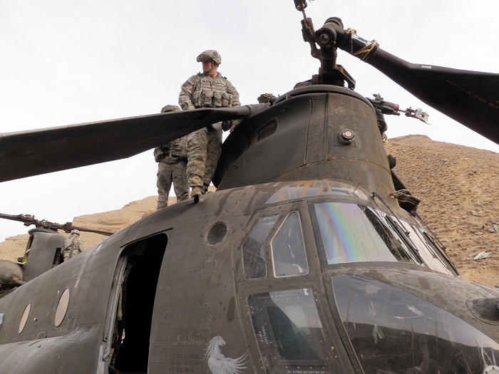 Elements of B Company, 603rd Aviation Support Battalion prepare for the removal of the remains of the forward rotor blades to facilitate the slinging of CH-47D Chinook helicopter 87-00082 from the crash site in Afghanistan.
