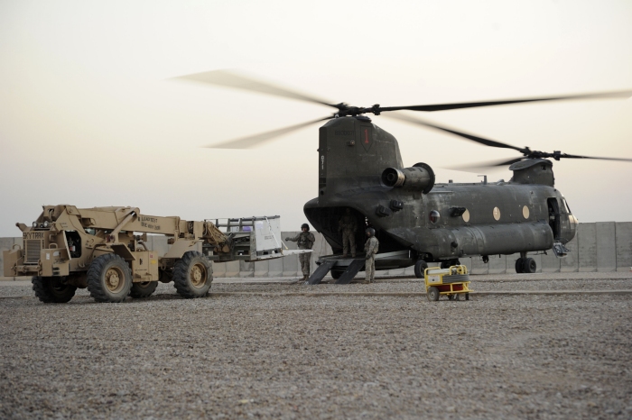 15 November 2010: U.S. Army SPC Sean Barry from Albuquerque, New Mexico, of Alpha Company, 2nd Brigade Support Battalion, 2nd Advise and Assist Brigade, 25th Infantry Division, loads Stryker parts onto Chinook helicopter 88-00071 at Forward Operating Base Warhorse in Diyala Province, Iraq. Chinooks are being used to transport supplies throughout Iraq for Operation New Dawn.