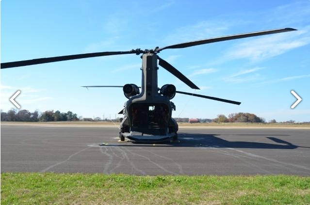 A view from behind of CH-47D Chinook helicopter 88-00097 sitting at Madison Executive Airport (KMDQ), Meridianville, Alabama, during the auction process as it went up for sale to the highest bidder on the commercial market.