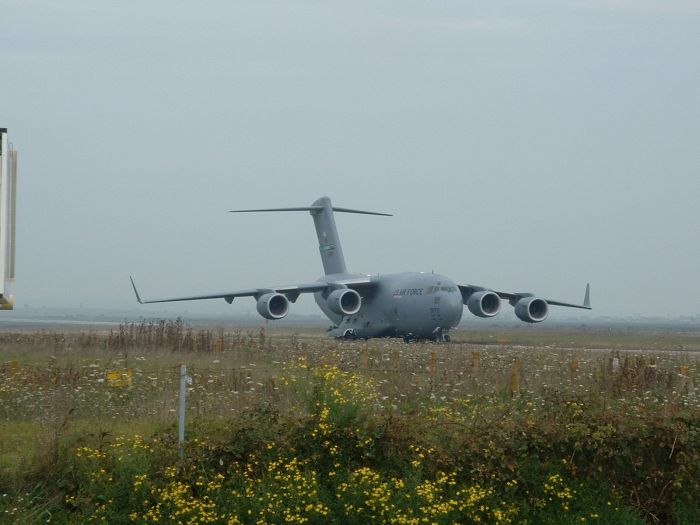 September 2002: The C-17 aircraft slowly rolls down the taxiway as it prepares to return 89-00138 to an unknown location in the Continental United States (CONUS) for major repair.
