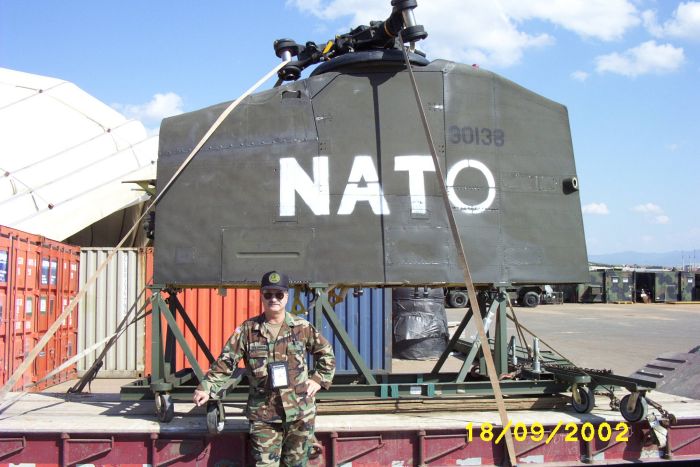 September 2002: An unknown individual poses next to the aft pylon of 89-00138 as it is preparing to take a ride aboard a United States Air Force (USAF) C-17 Globemaster III transport aircraft at Camp Able Sentry, Macedonia.