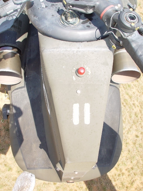 July 2002: A view of the top of the aft end of the aft pylon for those who have never seen it. Located here is the top Anti-Collision Light (red) and the two aft pylon Formation lights (they glow pale green at night and allow other aircraft in your formation to see you). Combined with the three Formation light mounted up forward on the top of the aircraft, all five Formation Lights form an arrow pointing in the direction the aircraft is travelling. The white colored light in between the anti-collision and formation lights is an infra-red formation light that can only be seen using Night Vision Goggles.