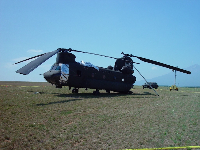 July 2002: Sitting in the grass at Camp Bondsteel, Serbia, this photograph shows 89-00138 in the days following the accident. Support personnel have covered the vunerable areas with protective barrier material to prevent further damage.