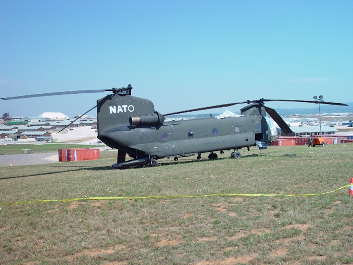 July 2002: Sitting in the grass at Camp Bondsteel, Serbia, this photograph shows 89-00138 in the days following the accident. Support personnel have covered the vunerable areas with protective barrier material to prevent further damage.