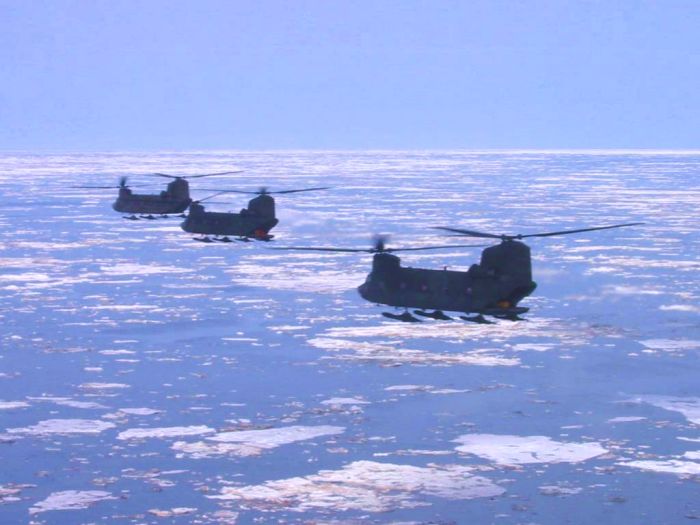 Four Boeing CH-47D Chinooks cruise over the Artic Ocean.
