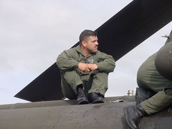 Technical Inspector SSG Jose Juvera looks on as the Flight Engineer and Crew Chief finish the installation.