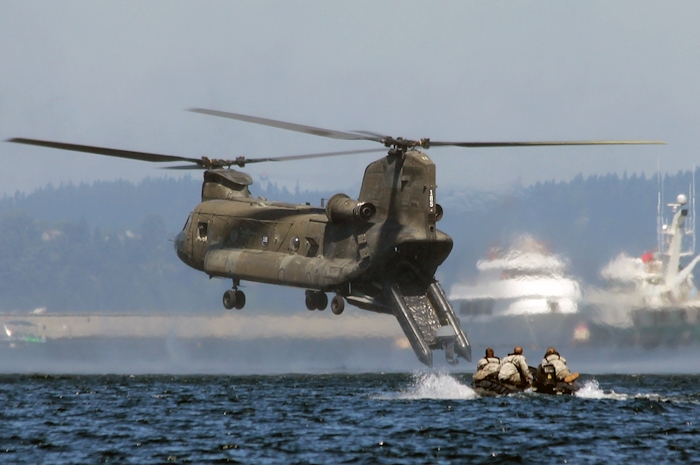 CH-47D Chinook helicopter 90-00185, based at Gray Army Airfield (KGRF), Joint Base Lewis McChord, drops a semi-rigid inflatable boat out the back in preperation to drop US Army Reserve Special Forces Soldiers for a demonstration during the 2012 Seattle Seafair.