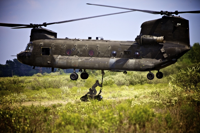 11 September 2011: Two Soldiers with the Army Reserve's 739th Engineer Company in Granite City, hook a sling to the bottom of an Illinois Army National Guard CH-47D Chinook at the Sparta Training Area.