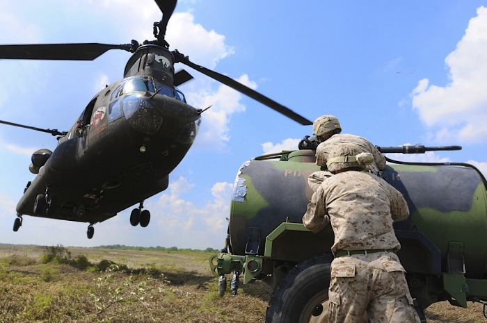11 September 2011: Marine Corps Corporal Festus Blecha and Corporal Jacob Basler prepare to make a sling load hookup to a passing Illinois Army National Guard CH-47 Chinook helicopter at the Sparta Training Area.