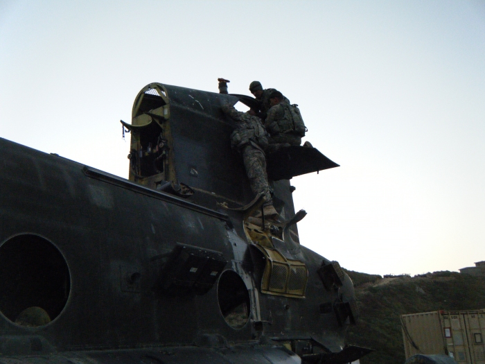 Elements of B Company, 603rd Aviation Support Battalion prepare the aft shaft for removal to facilitate the sling loading of 92-00291 from the landing zone (LZ) at Ghaki Pass.