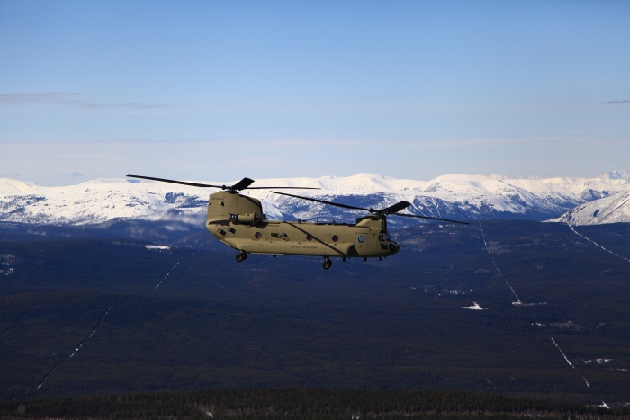 17 April 2012: CH-47F Chinook helicopter 08-08764, lead ship of Sortie 1 on the ferry flight to Alaska, flies along the Alaska Canada Highway (ALCAN) north of Fort St. John. In the background is the northern end of the Rocky Mountains. The lead aircraft in the flight of four helicopters was piloted by Tim McCall (PC), CW4 Sean Barcoe (PI), and proudly crewed by Robert Simpson (SI).