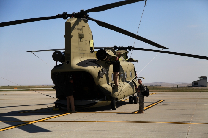 11 April 2012: On the Army National Guard ramp at Rapid City, South Dakota, Tim McCall preflights CH-47F Chinook helicopter 08-08764 for the next day's flight as LTC Brad Killen discusses the events of the day.