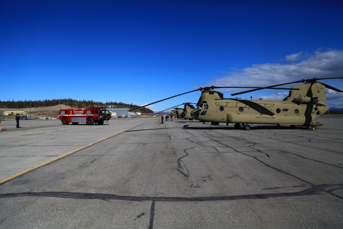18 April 2012: CH-47F Chinook helicopter ferry flight Sortie 1 parked on the ramp at Whitehorse International Airport, Yukon, Canada. Lined up in Chalk order, 08-08764 is in the foreground in this photograph. The stop was a quick turn for refuel before we blasted off to our final destination - Ladd Field. Everywhere we stopped along the way we met people who were fascinated with the new F model Chinook. We must have given a hundred tours of the birds.