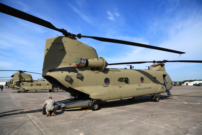 9 April 2012: CW4 Bruce Linton loads some personal gear aboard CH-47F Chinook helicopter 08-08771 while on the ramp at Hunter Army Airfield, Georgia.