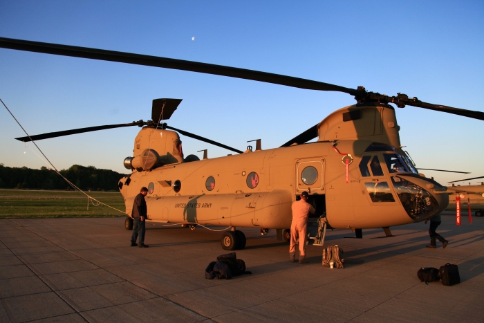 11 April 2012: CH-47F Chinook helicopter 08-08771 being prepped for flight at sunrise while parked on the ramp at the Spirit of St. Louis Airport.