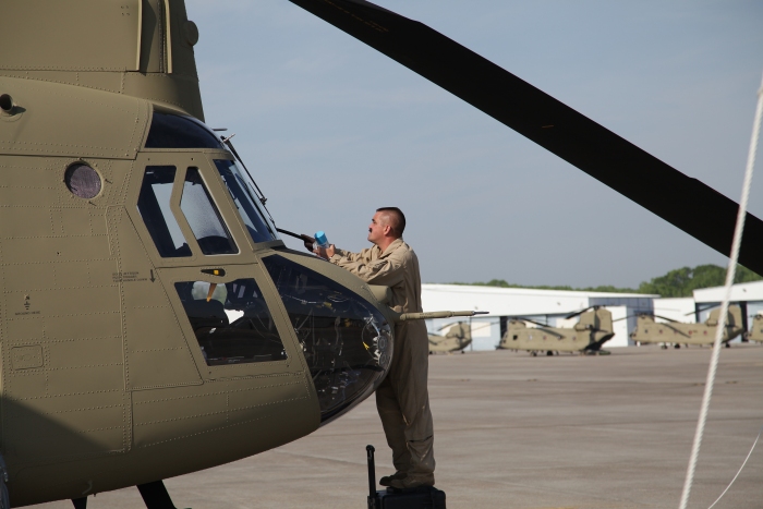 S3's NET Team Flight Engineer Bruice Cain cleans the windows of CH-47F Chinook helicopter 08-08775 while it is parked on the ramp at Hunter Army Airfield, Georgia, 29 March 2012.