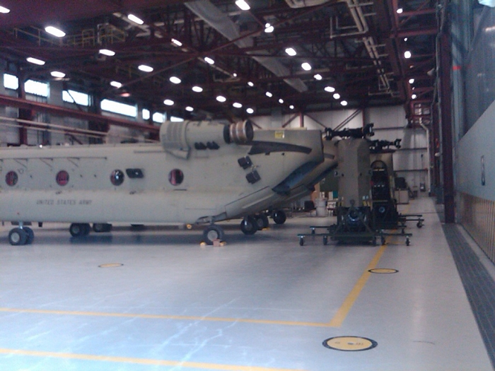 In the hangar, CH-47F Chinook helicopter 09-08060 and a sister ship await loading onto a C-17 for deployment to Afghanistan.