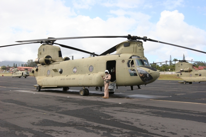 8 December 2011: Randy Enger, S3 Incorporated New Equipment Training Team Flight Engineer, stands ready for engine start next to CH-47F Chinook helicopter 09-08065 on the Army National Guard Ramp at Wheeler Army Airfield. The aircraft was assigned to Company B -  "Voyagers", 171st Aviation, in November 2011.
