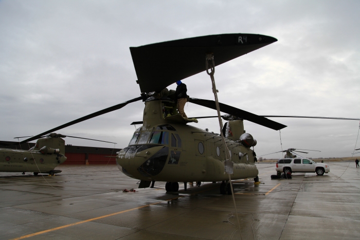 15 April 2012: CH-47F Chinook helicopter 10-08082 parked on the ramp at Helena, Montana, after a remain overnight (RON) stop. During the night low temperatures and snow led to a coating of ice on the aircraft that required removal prior to departure.