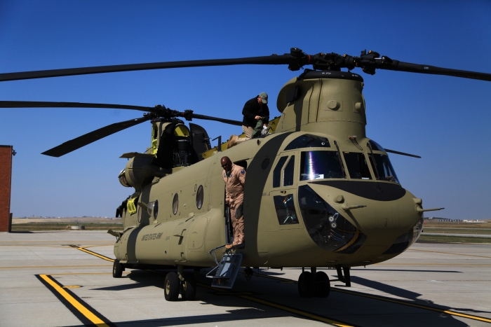 11 April 2012: Flight Engineer Doug Grade puts 10-08083 to bed as Rich Davis III steps out the main cabin door while parked on the ramp at Rapid City (KRAP), South Dakota.