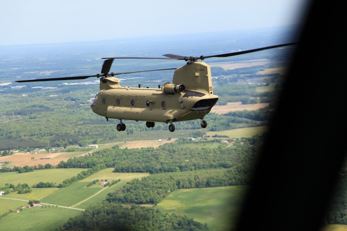 10 April 2012: CH-47F Chinook helicopter 10-08083 in flight just north of Hunter Army Airfield as Sortie 1 begins the first leg enroute to Alaska.