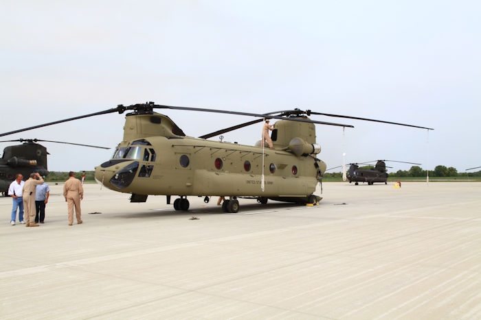 20 September 2012: CH-47F Chinook helicopter 10-08806 gets put to bed after arriving at Marshall Army Airfield (KFRI). NET Team Flight Engineer George Hall assists in securing the top of the aircraft as the flight crew packs up their gear. Parked to the right of 10-08806 is D model Chinook helicopter 87-00072, originally fielded to the 205th Aviation Company then stationed at Mainz-Finthen, West Germany.